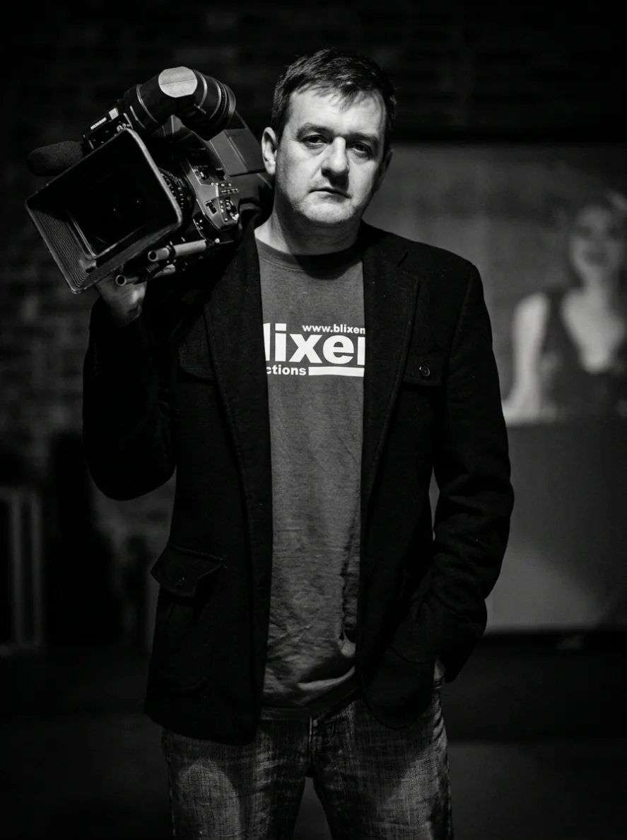 Founder André Calitz of Blixem Productions with a broadcast video camera on his shoulder